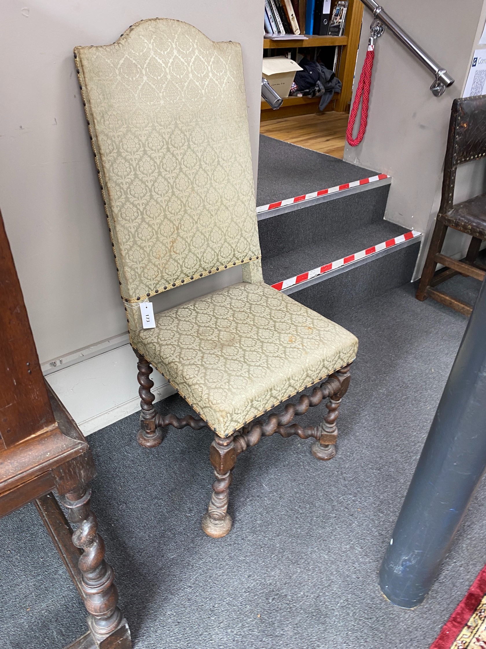 A pair of late 17th century walnut hall chairs with upholstered backs and seats on barley twist underframes, width 48cm, height 118cm